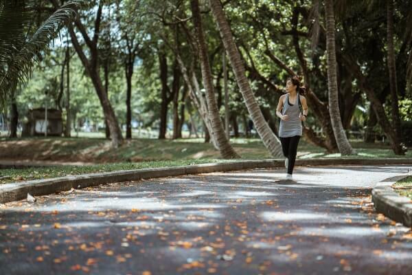 A community member runs through a neighborhood park. 