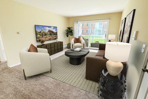 Modern living room with beige walls, cozy seating, coffee table, TV, and large window with view.