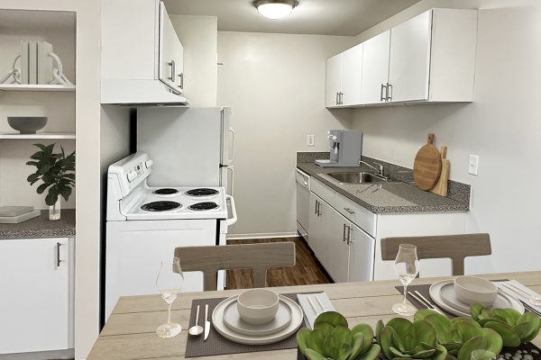 Modern kitchen with white cabinets, cozy dining area, and countertop decor, featuring plants and kitchen essentials.