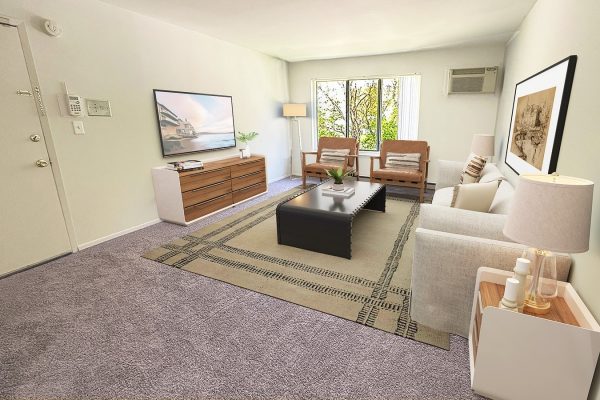Modern living room with natural light, cozy furniture, and a TV on a wooden console. Elegant and inviting atmosphere.