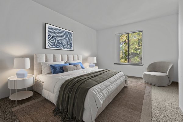 Modern bedroom with a cozy bed, stylish lamps, abstract artwork, and a window view of trees.