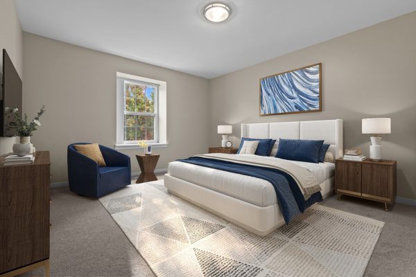Modern bedroom with beige walls, blue accents, large bed, and natural light through a window. Cozy and stylish design.