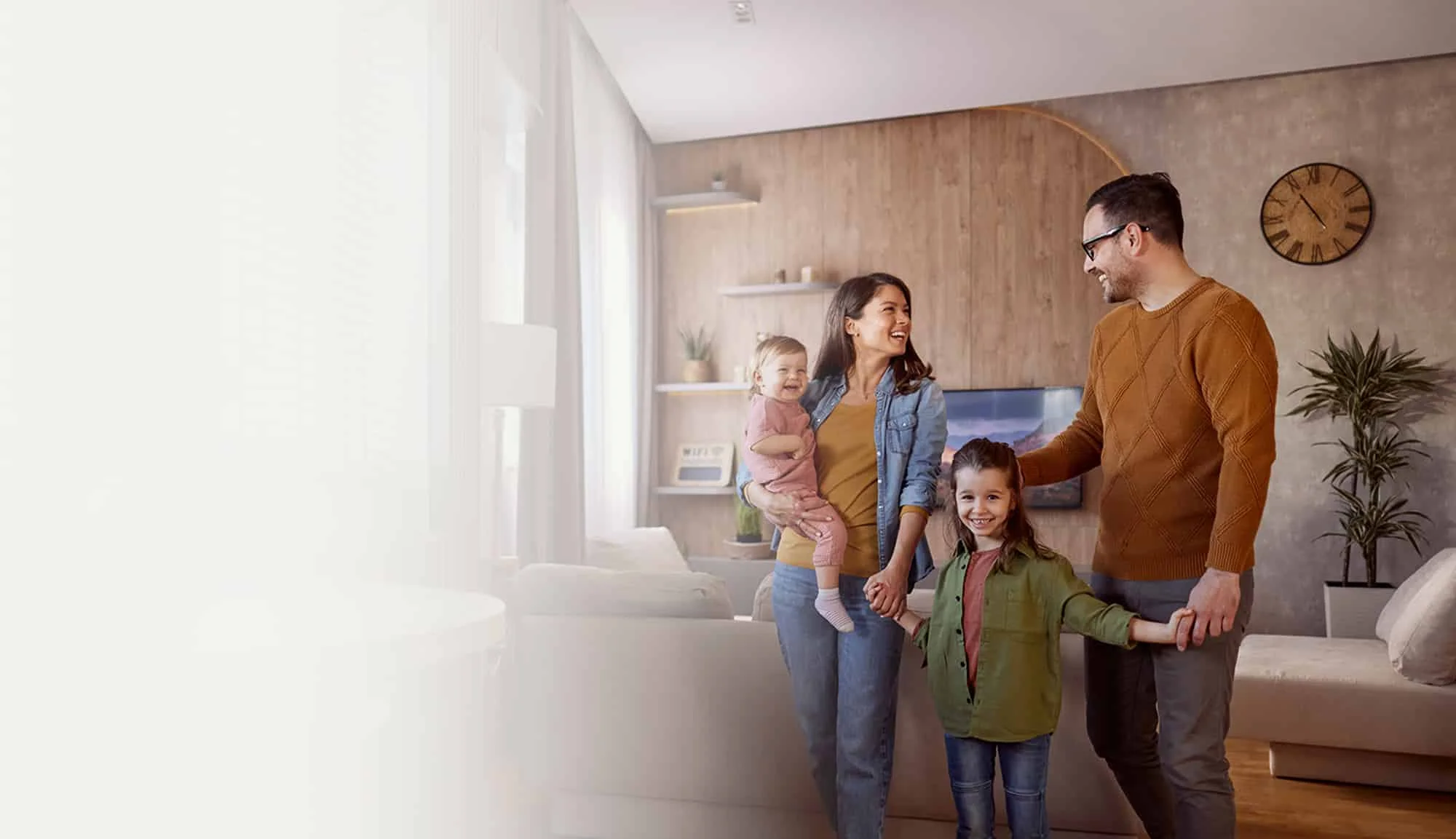 Happy family enjoying quality time together in a cozy living room, smiling and bonding.